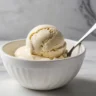 Scoop of homemade breast milk ice cream in a small ceramic bowl